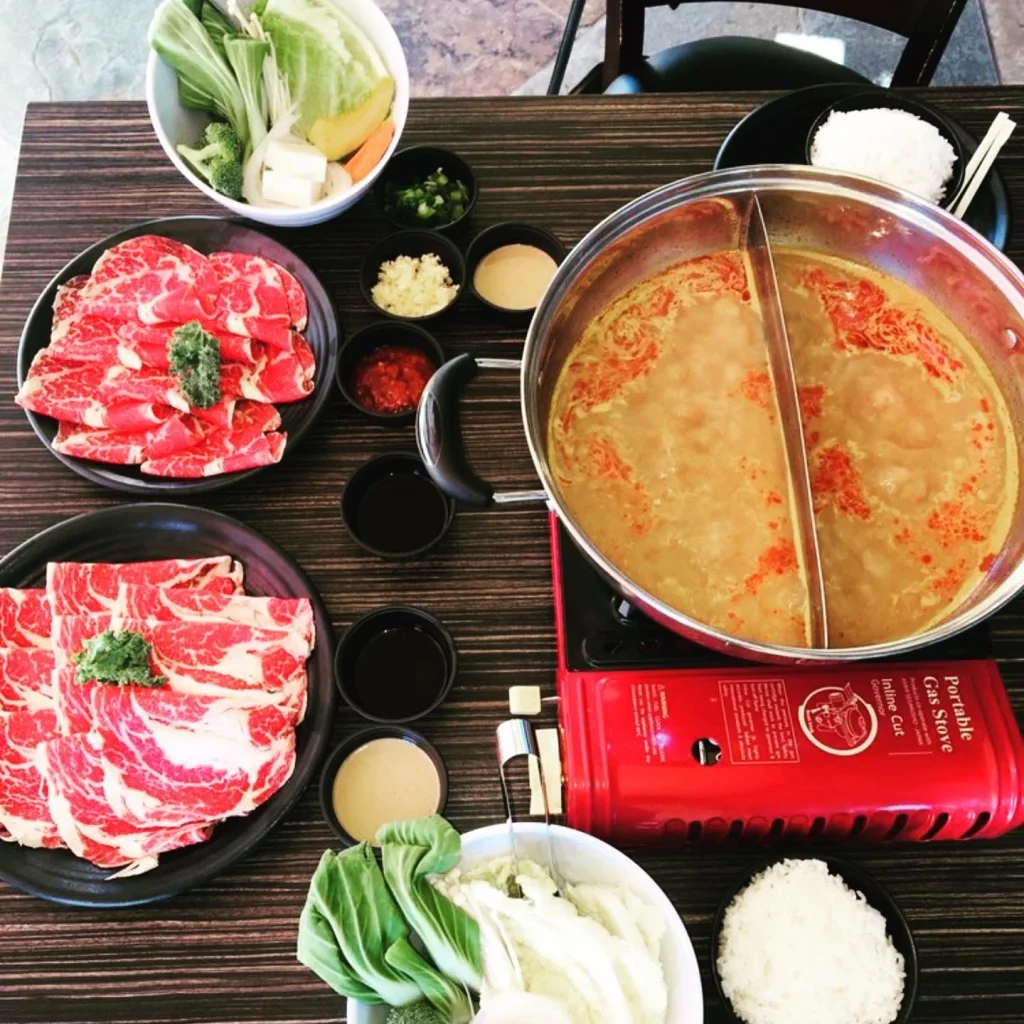 Hot pot with sliced beef, vegetables and broth